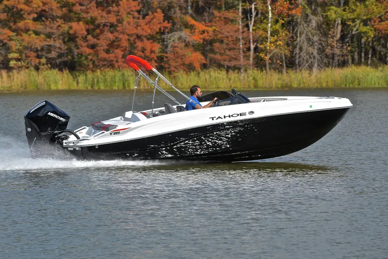 Slide: The Image of 2024 Tahoe T21 boat cruising on a lake with autumn foliage in the background. - 3