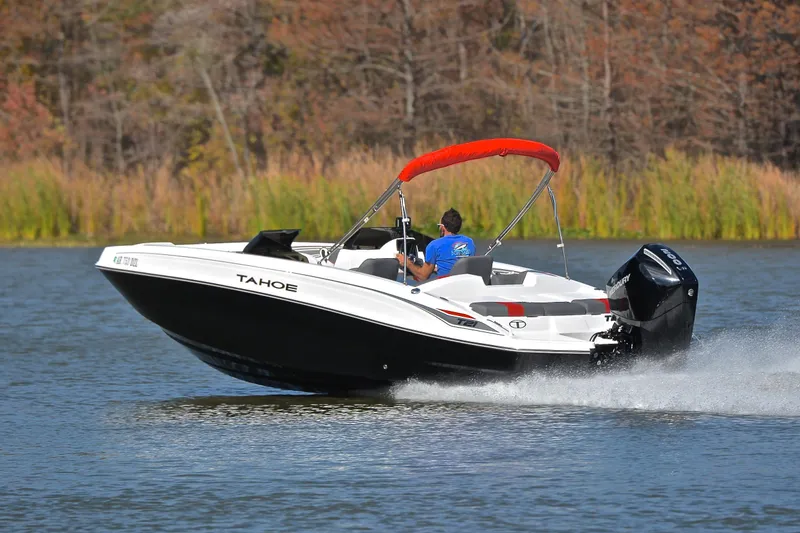 Slide: The Image of 2024 Tahoe T21 boat cruising on a lake with a vibrant red canopy. - 4