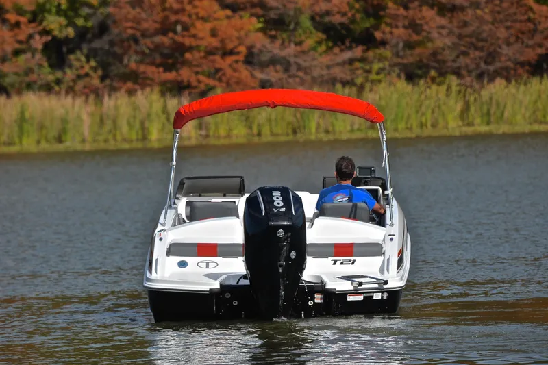Slide: The Image of 2024 Tahoe T21 boat cruising on a lake with autumn foliage backdrop. - 8