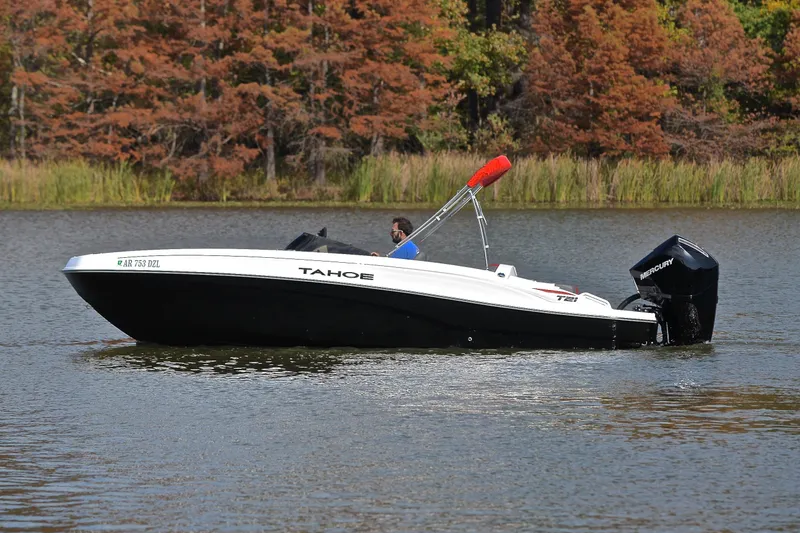 Slide: The Image of 2024 Tahoe T21 boat cruising on a lake with autumn trees in the background. - 9