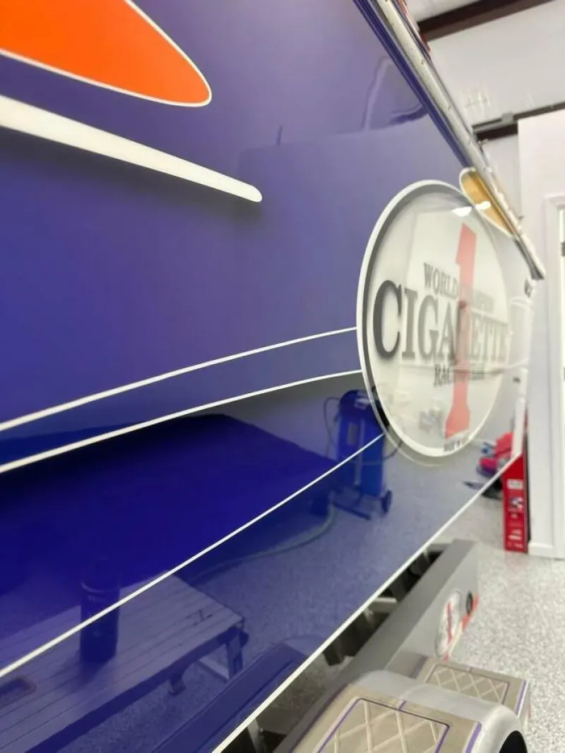 Slide: The Image of 2005 Cigarette 39 Top Gun boat, blue exterior with logo, sleek design. - 11