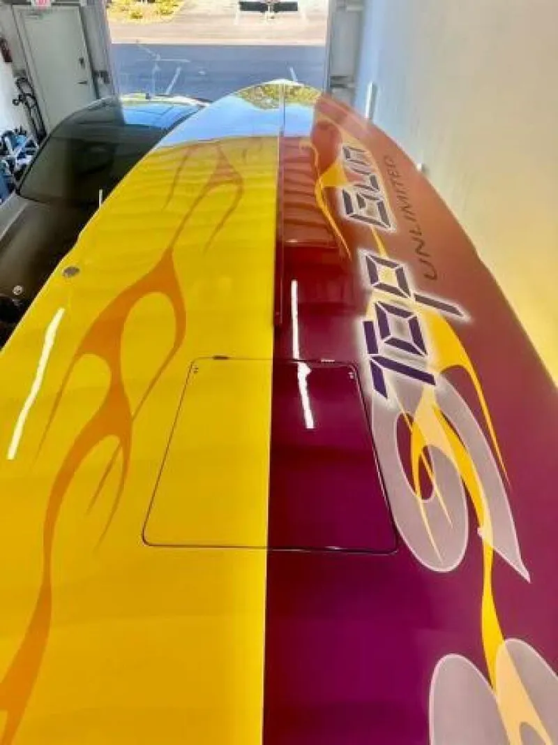 Slide: The Image of 2005 Cigarette 39 Top Gun boat with vibrant yellow and red flame design. - 14