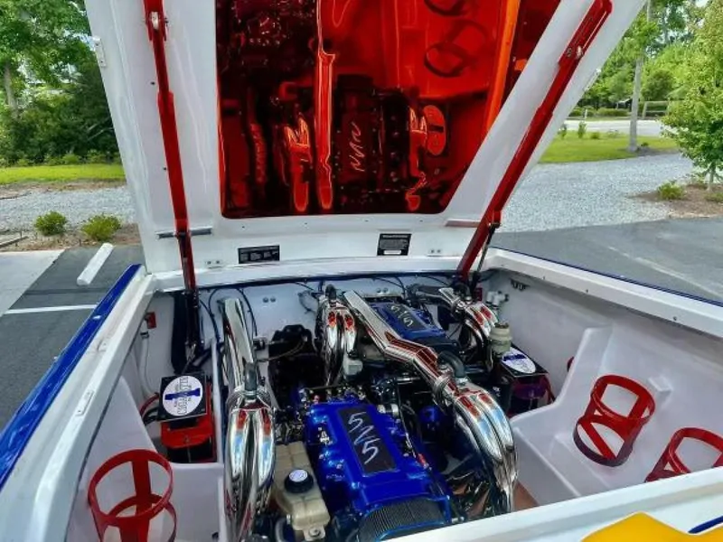 Slide: The Image of Engine compartment of a 2005 Cigarette 39 Top Gun boat with chrome and blue accents. - 22