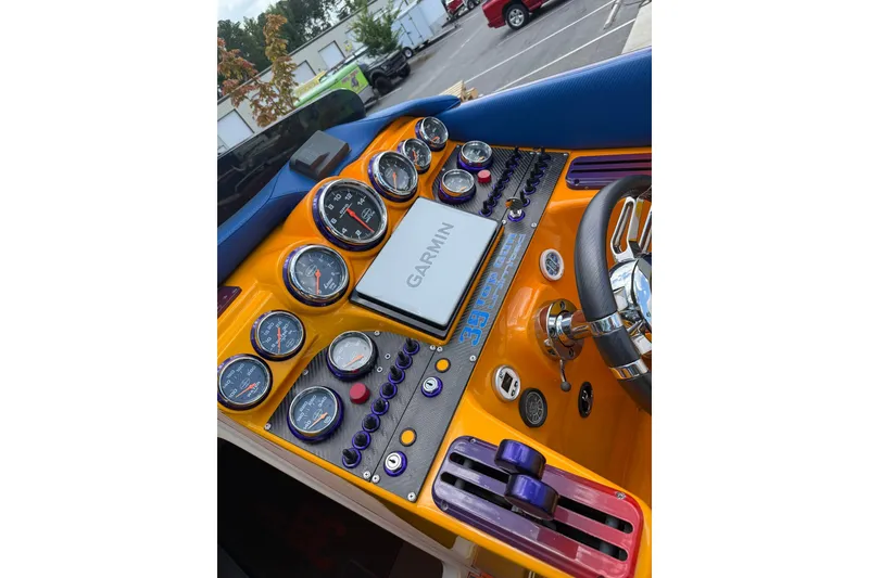 Slide: The Image of Dashboard of a 2005 Cigarette 39 Top Gun Unlimited boat with gauges and Garmin display. - 31