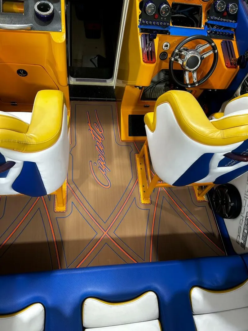 Slide: The Image of Interior of a 2005 Cigarette 39 Top Gun boat with vibrant seating and detailed dashboard. - 7