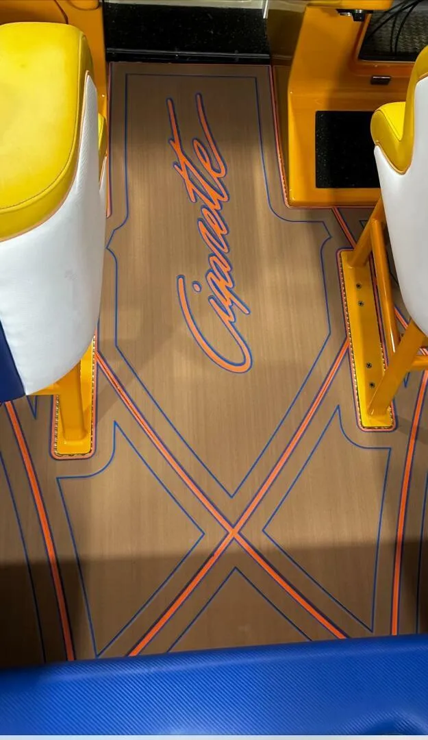 Slide: The Image of 2005 Cigarette 39 Top Gun boat interior with custom flooring and vibrant seating. - 8