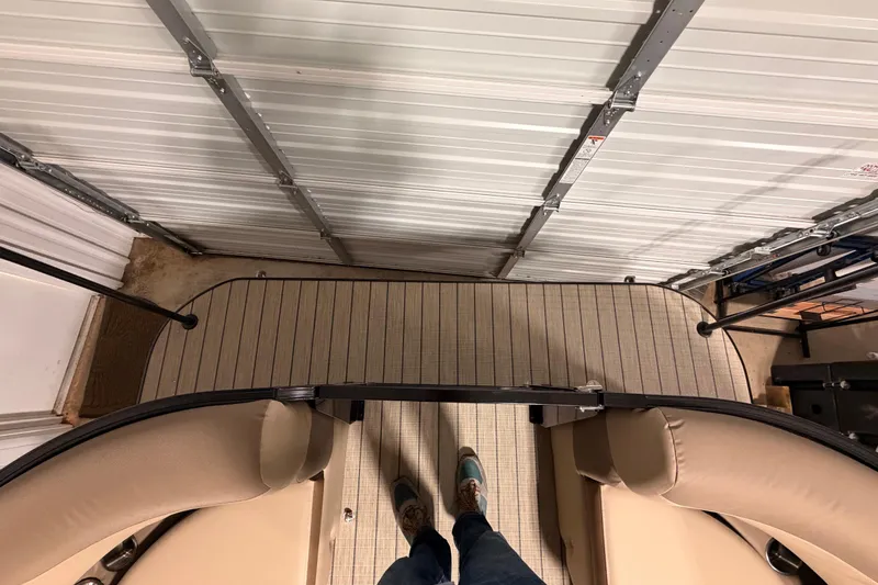 Slide: The Image of 2026 Veranda VR 265 VL pontoon boat interior with beige seating and striped flooring. - 12