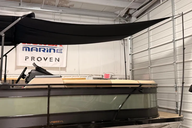 Slide: The Image of 2026 Veranda VR 265 VL pontoon boat in showroom with canopy and Honda Marine banner. - 21