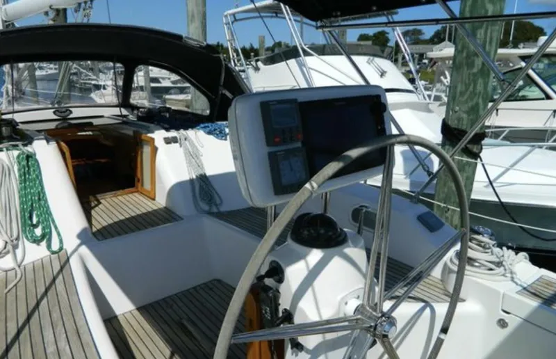 Slide: The Image of 2003 Wauquiez 40 Pilot Saloon yacht cockpit with steering wheel and navigation equipment. - 10
