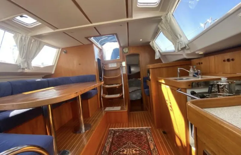Slide: The Image of Interior of 2003 Wauquiez 40 Pilot Saloon yacht with wooden finish and spacious seating area. - 13