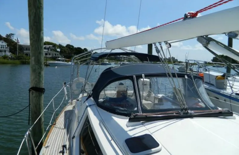 Slide: The Image of 2003 Wauquiez 40 Pilot Saloon yacht docked in a serene marina setting. - 7