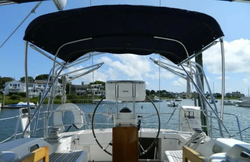 Slide: The Image of 2003 Wauquiez 40 Pilot Saloon yacht cockpit with steering wheel and canopy. - 8