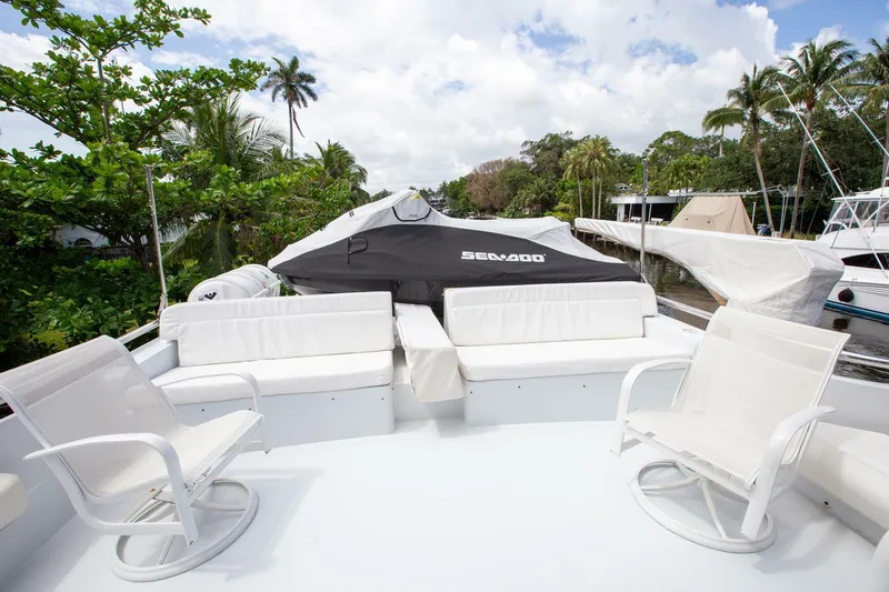 Slide: The Image of Luxurious 1999 Tarrab Motor Yacht deck with white seating and Sea-Doo jet ski. - 27