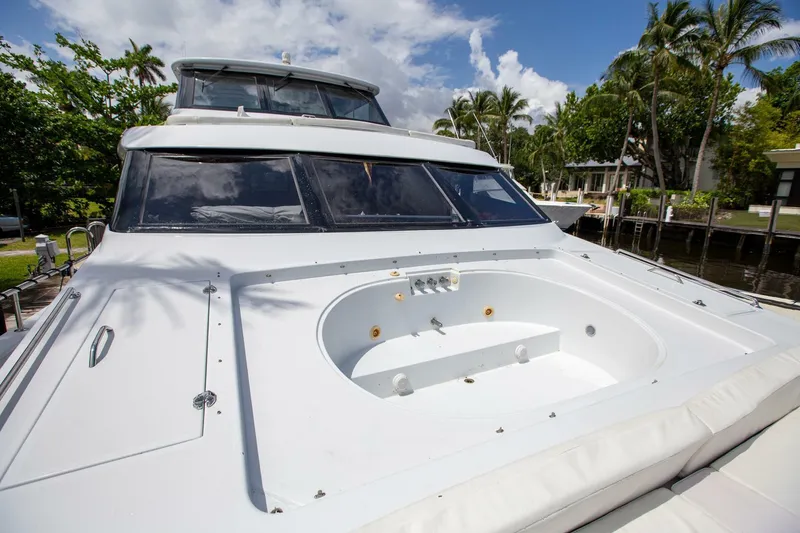 Slide: The Image of Tarrab 1999 motor yacht with spacious deck and jacuzzi, surrounded by tropical scenery. - 39