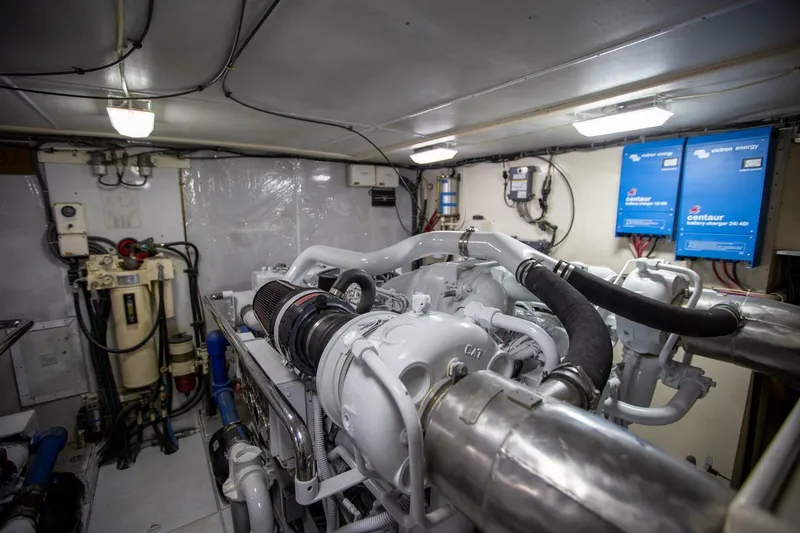 Slide: The Image of Engine room of a 1999 Tarrab Motor Yacht, featuring complex machinery and control panels. - 42