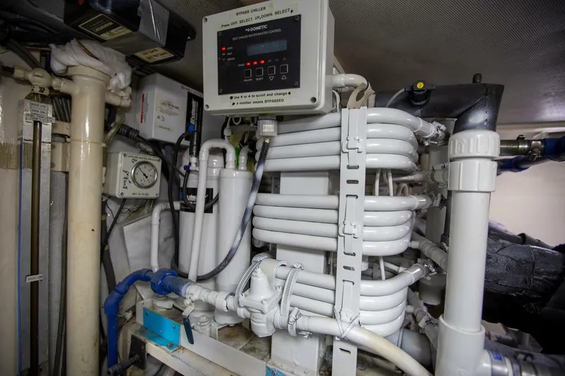 Slide: The Image of Engine room of a 1999 Tarrab Motor Yacht, featuring complex piping and control systems. - 44
