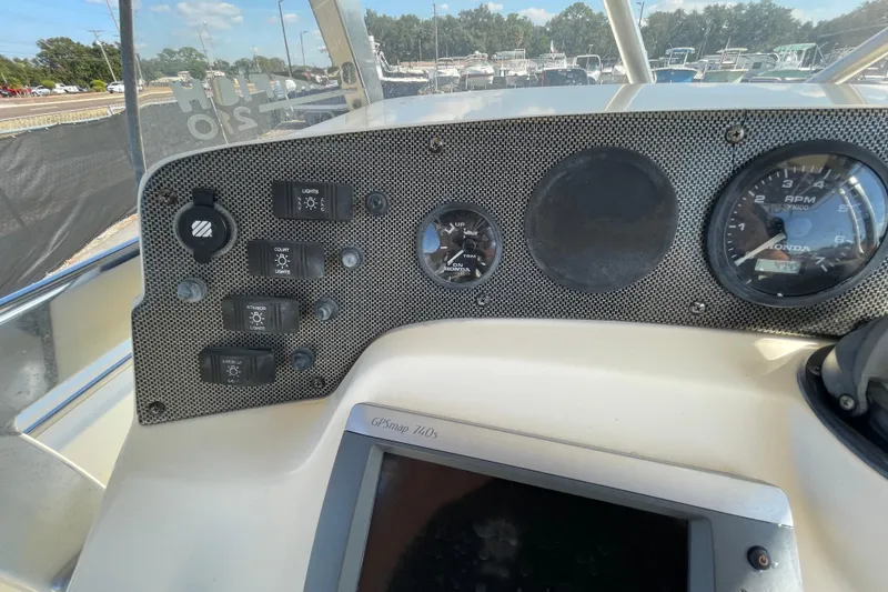 Slide: The Image of Boat dashboard with control switches, gauges, and GPSmap 740s, SC make, year 2000. - 22
