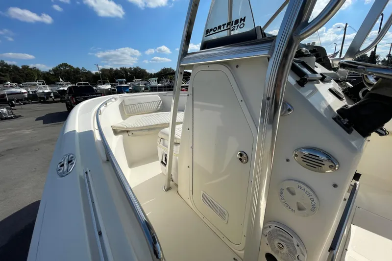 Slide: The Image of Center console of a 2000 SC Sportfish 210 boat, featuring seating and washdown system. - 28