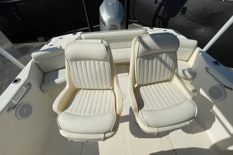 Slide: The Image of Two white boat seats on a 2000 SC model, with a Honda 150 engine. - 47