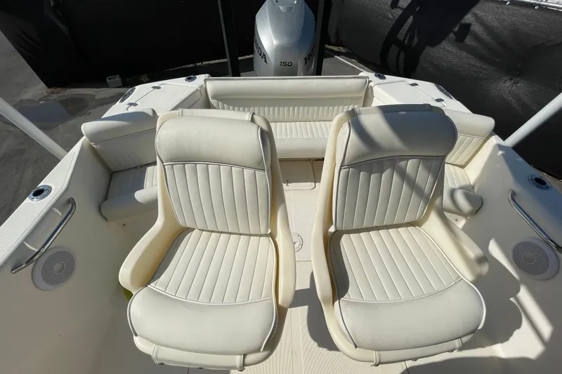 Slide: The Image of Two white boat seats on a 2000 SC model, with a Honda outboard motor. - 48