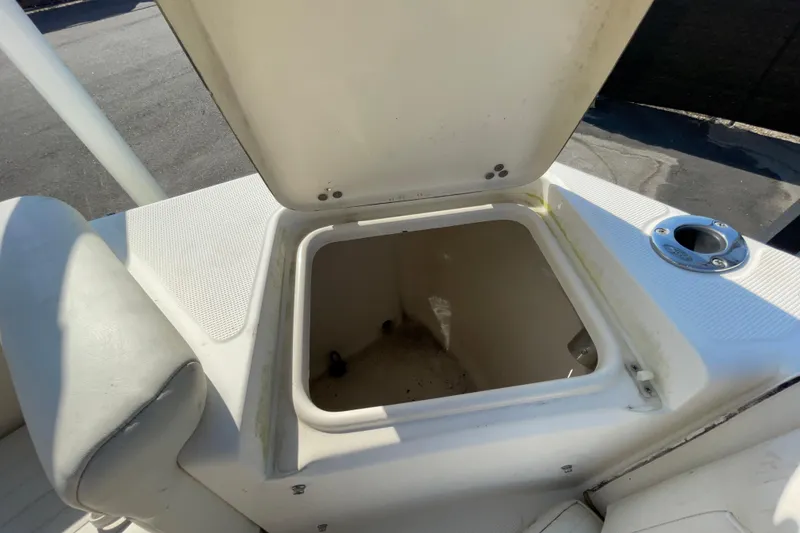 Slide: The Image of Open storage compartment on a 2000 SC boat, showing interior details. - 53