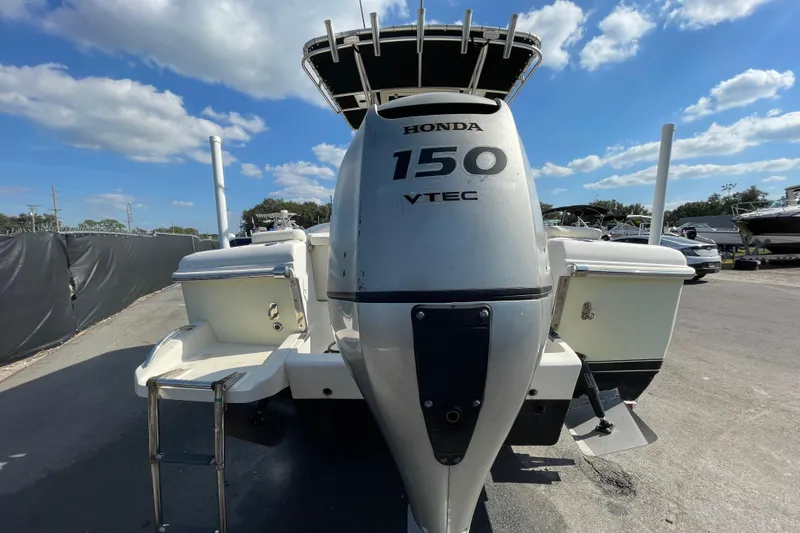 Slide: The Image of Outboard motor on a 2000 SC boat, Honda 150 VTEC, parked outdoors. - 8