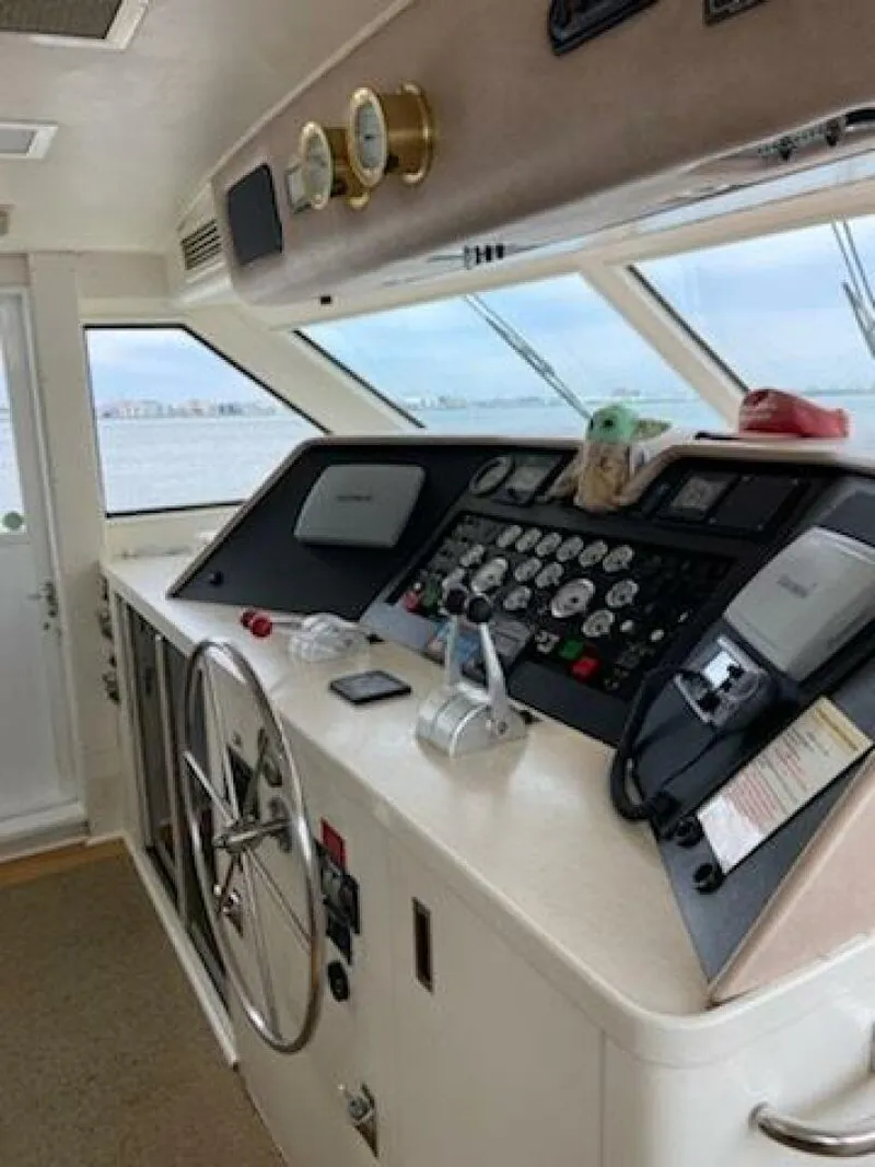 Slide: The Image of Interior of 1989 Hatteras Custom Cockpit yacht with sculpture and window view. - 15