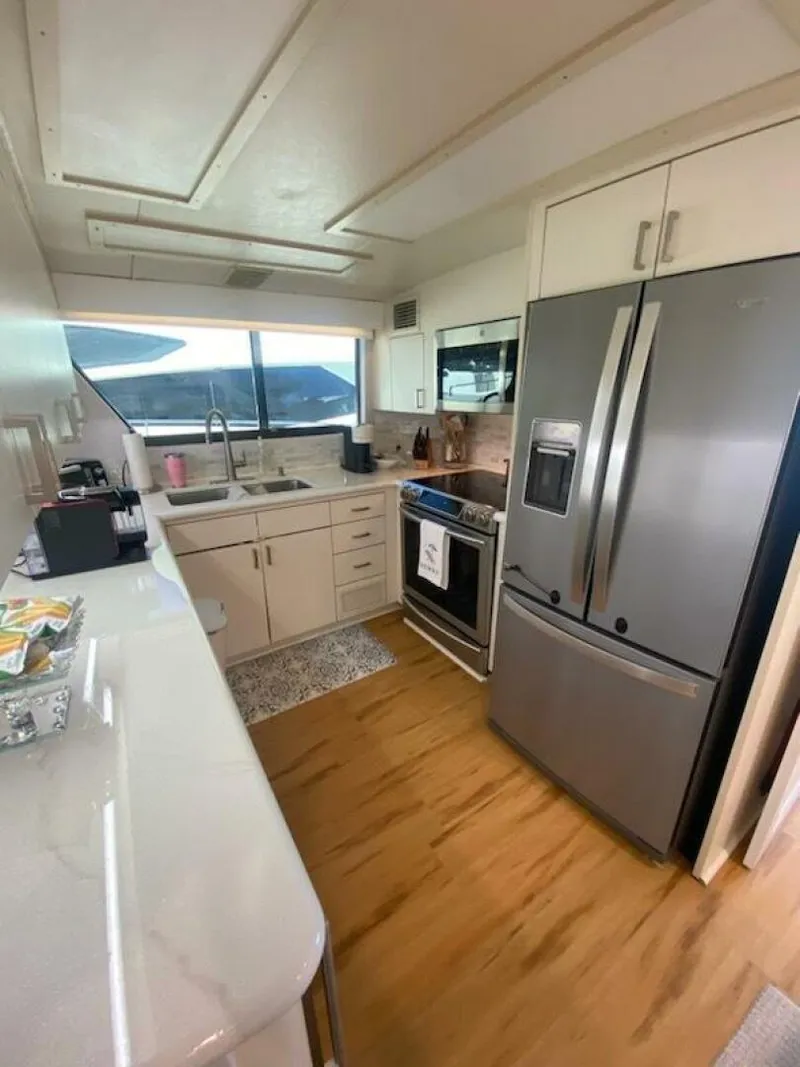 Slide: The Image of Modern kitchen in 1989 Hatteras Custom Cockpit yacht with stainless steel appliances. - 19