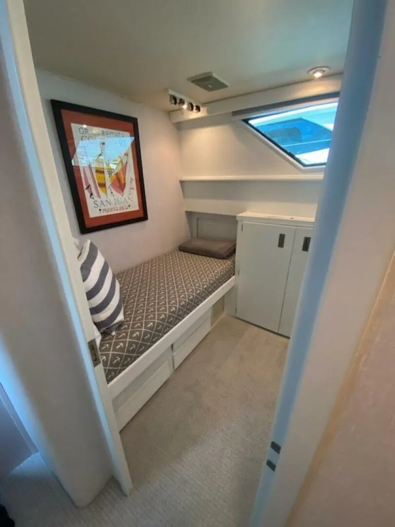 Slide: The Image of Luxurious 1989 Hatteras Custom Cockpit yacht bedroom with elegant decor and ample natural light. - 28