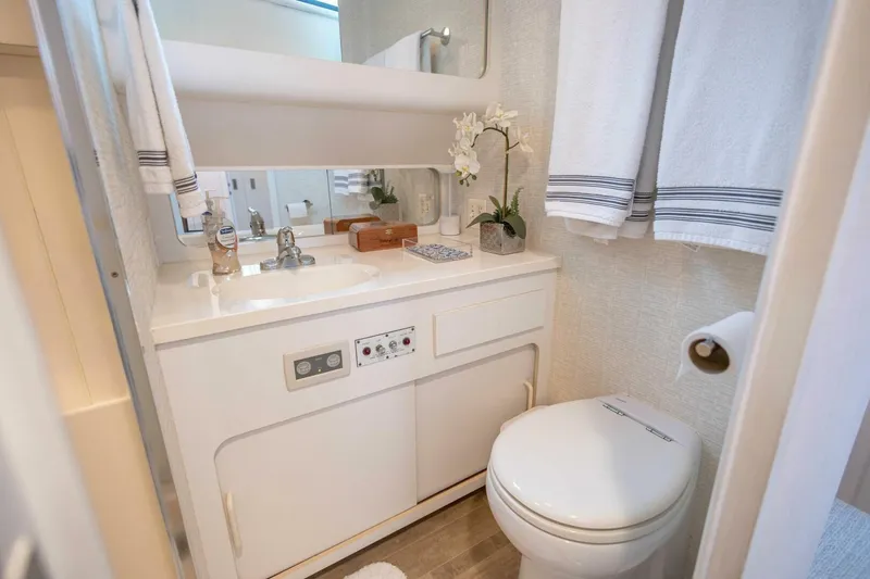 Slide: The Image of Luxurious 1989 Hatteras Custom Cockpit yacht bathroom with modern amenities and elegant decor. - 41
