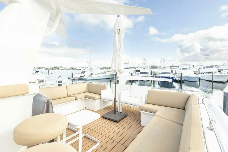 Slide: The Image of Luxurious 1989 Hatteras Custom Cockpit yacht with spacious seating and marina view. - 48