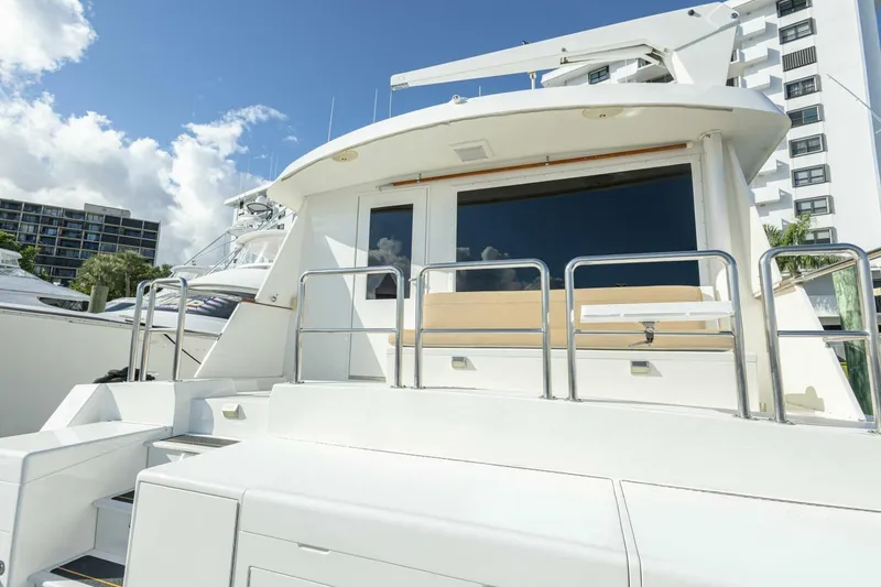 Slide: The Image of 1989 Hatteras Custom Cockpit yacht with sleek design and modern features, docked under blue sky. - 60