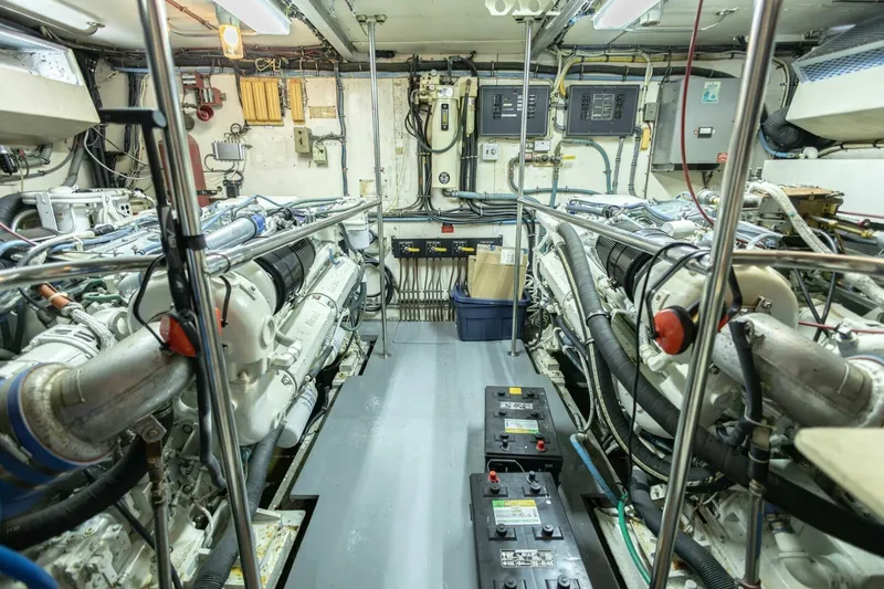 Slide: The Image of Engine room of 1989 Hatteras Custom Cockpit yacht with complex machinery and wiring. - 62