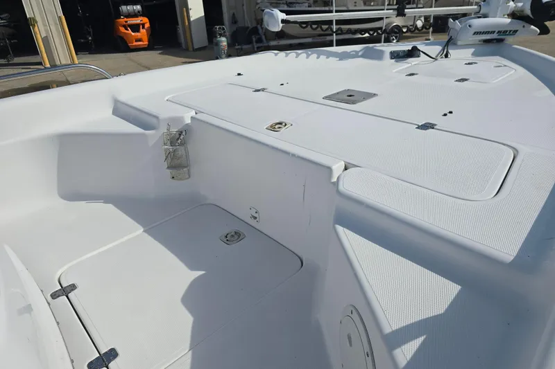 Slide: The Image of 2004 Fishmaster 1960 boat deck with storage compartments and trolling motor. - 10