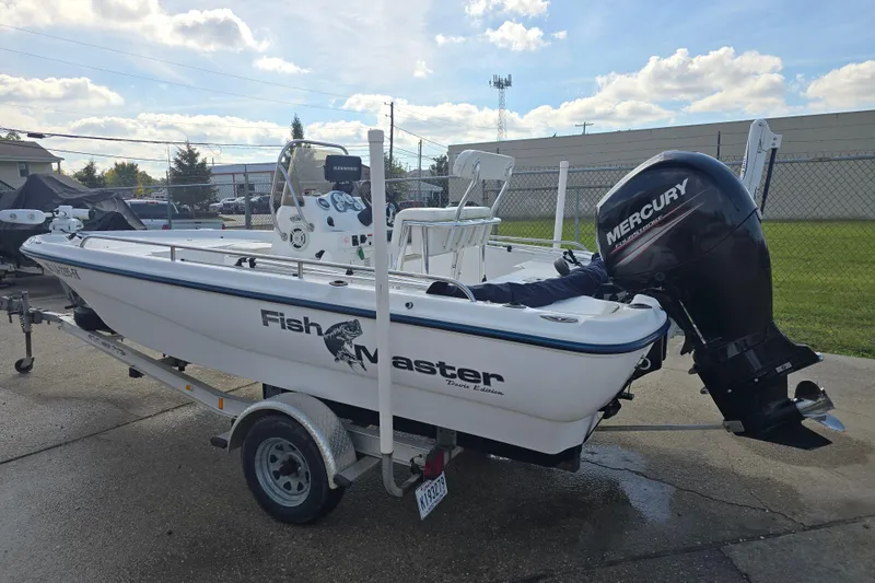 Slide: The Image of Fishmaster 1960 boat, 2004 model, with Mercury outboard motor on a trailer. - 3