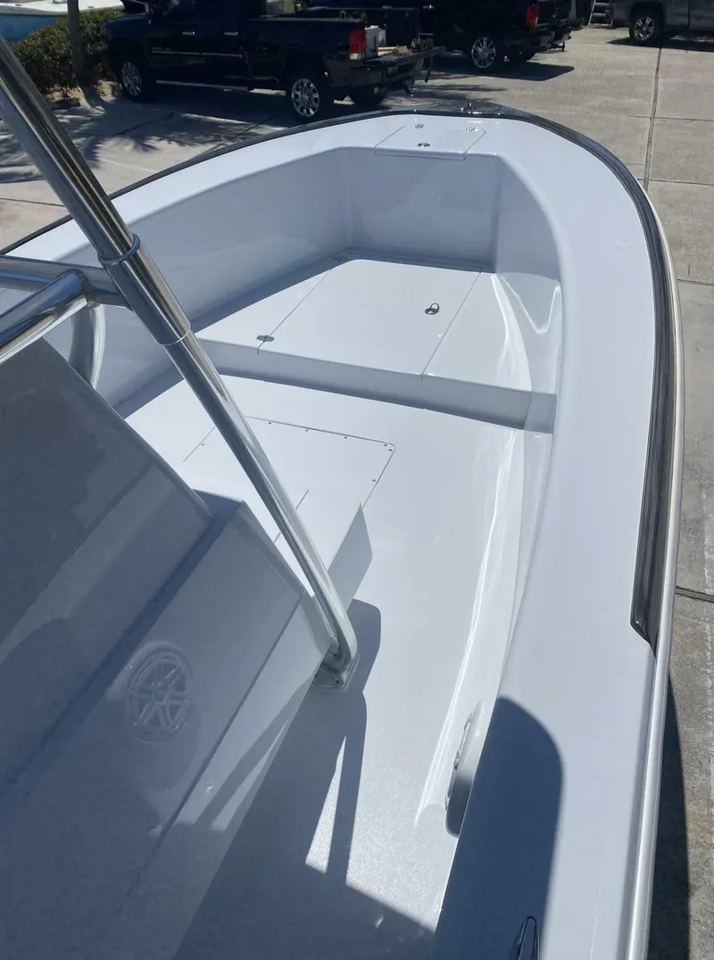 Slide: The Image of 1988 Intrepid 24 boat with sleek white deck and modern design. - 12