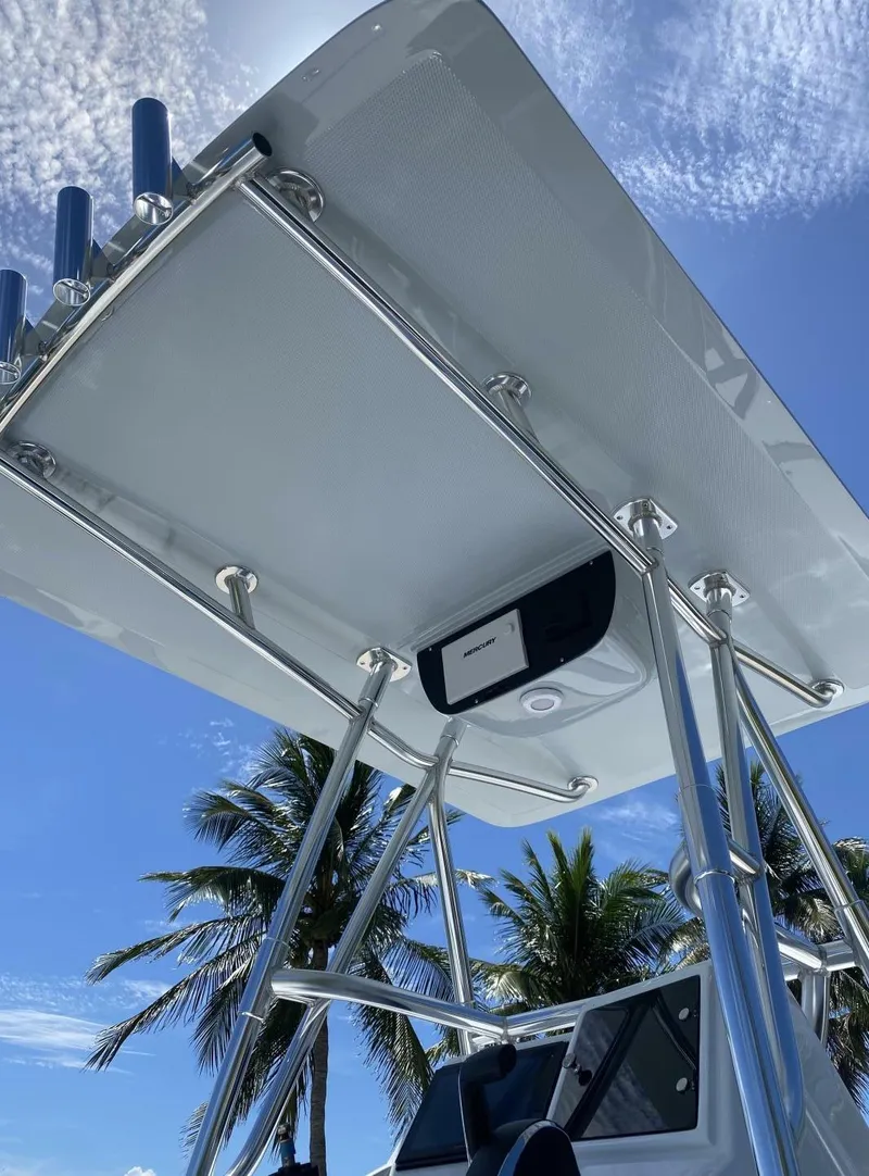 Slide: The Image of 1988 Intrepid 24 boat with T-top, clear sky, and palm trees in the background. - 14