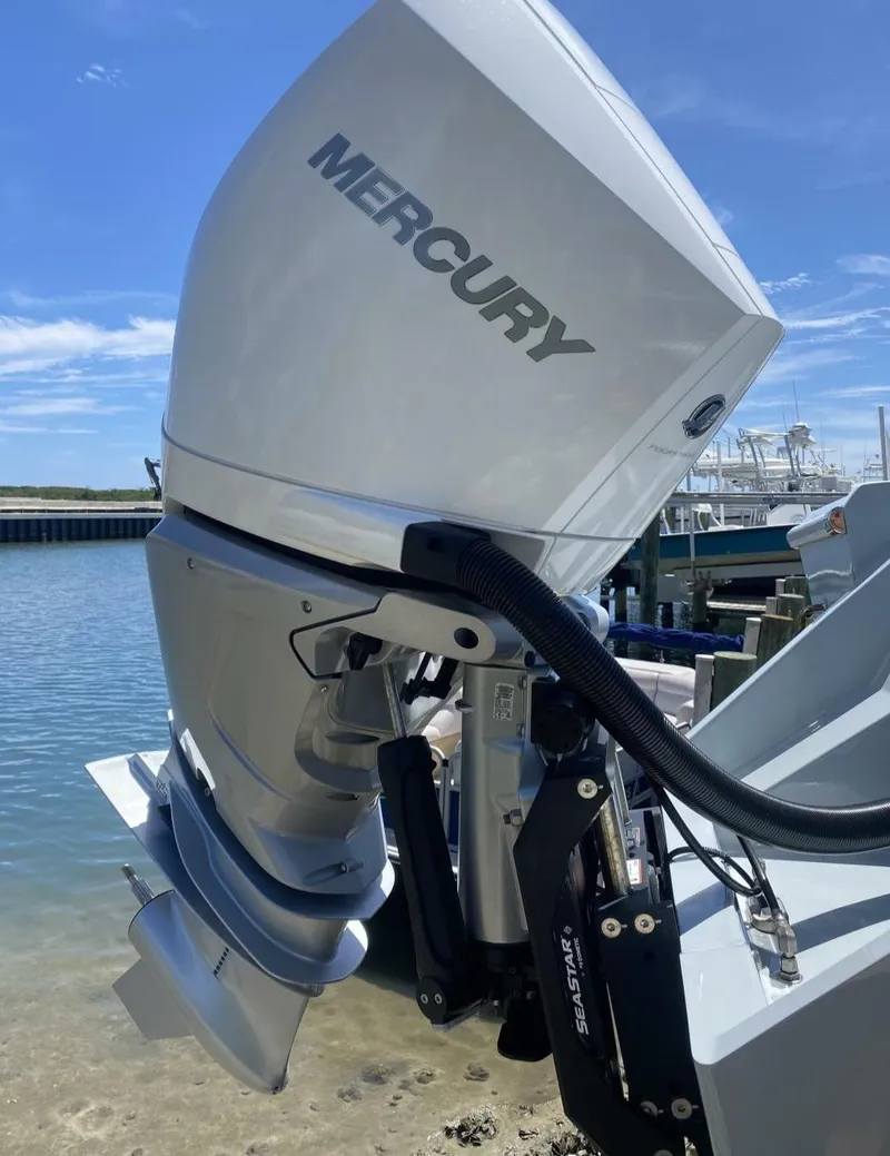 Slide: The Image of Outboard motor on 1988 Intrepid 24 boat, docked by the water. - 15