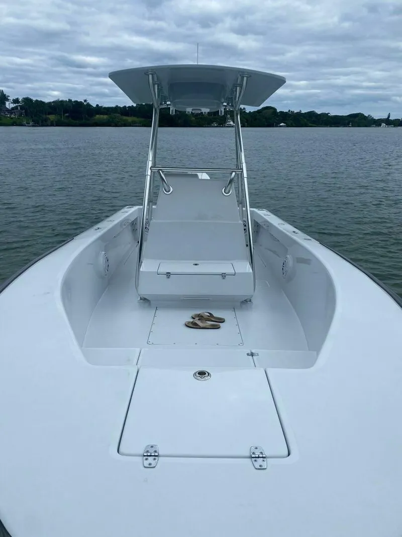 Slide: The Image of 1988 Intrepid 24 boat on calm water under cloudy sky. - 3