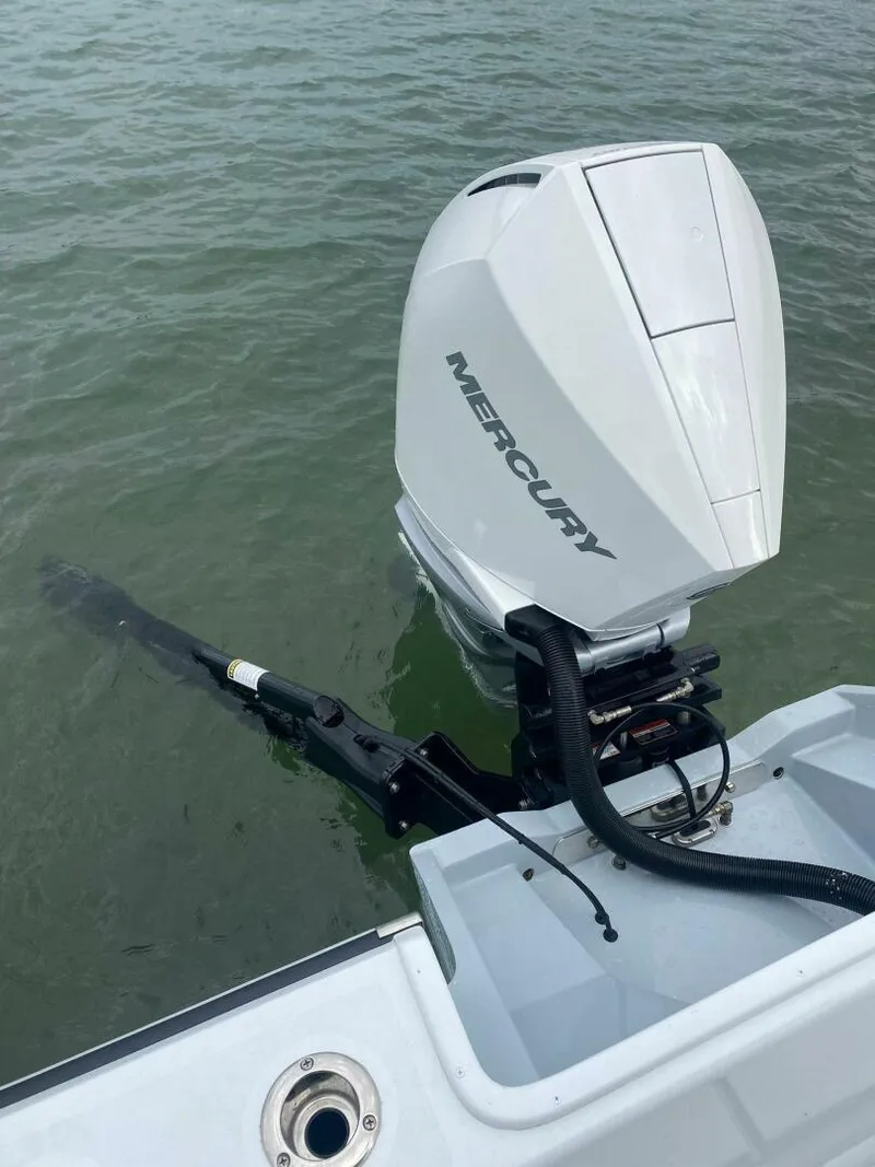 Slide: The Image of 1988 Intrepid 24 boat with Mercury outboard motor on water. - 7