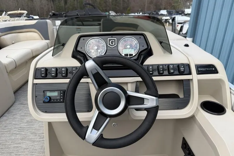 Slide: The Image of Steering console of 2026 Godfrey Sweetwater 2286 SFLC boat with modern controls and gauges. - 12