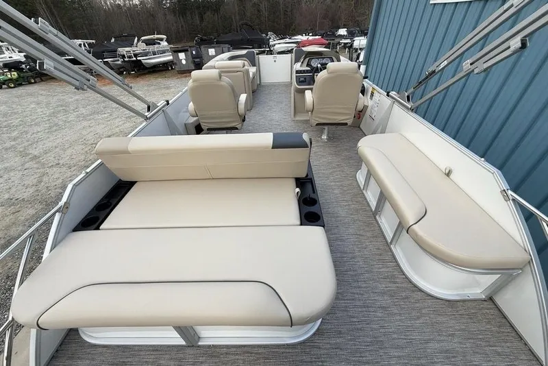 Slide: The Image of 2026 Godfrey Sweetwater 2286 SFLC pontoon boat interior with beige seating and helm. - 22