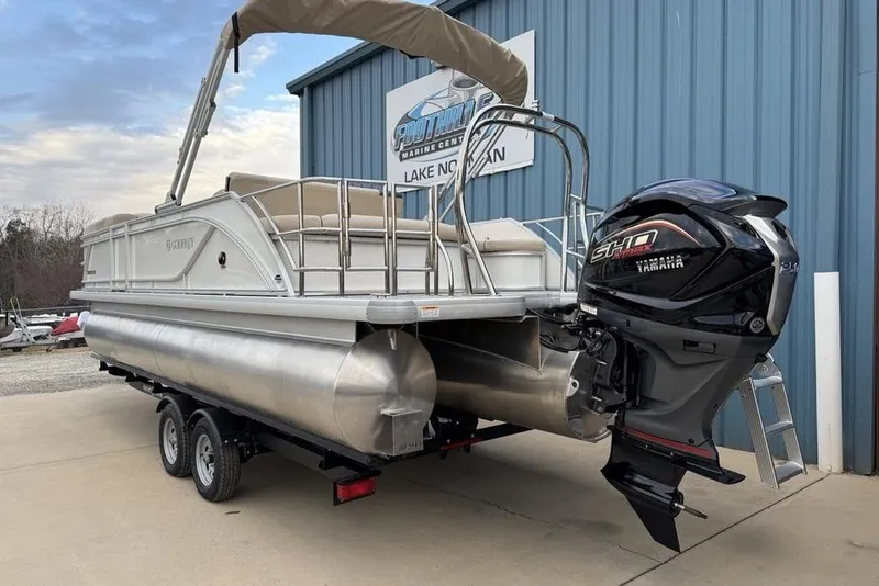Slide: The Image of 2026 Godfrey Sweetwater 2286 SFLC pontoon boat with Yamaha engine, parked on trailer. - 4