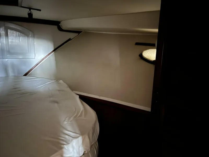 Slide: The Image of 1987 Californian 42 Motor Yacht cabin interior with bed and porthole. - 11