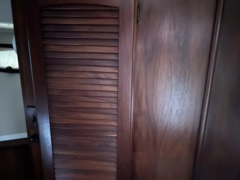 Slide: The Image of Wooden interior of 1987 Californian 42 Motor Yacht, featuring a louvered door. - 13