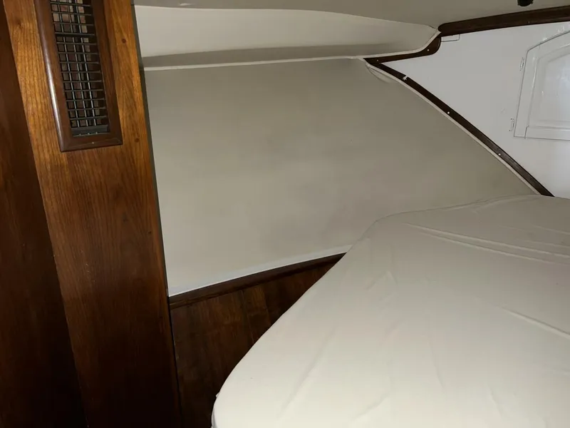 Slide: The Image of Interior cabin of 1987 Californian 42 Motor Yacht with wooden paneling and bed. - 16