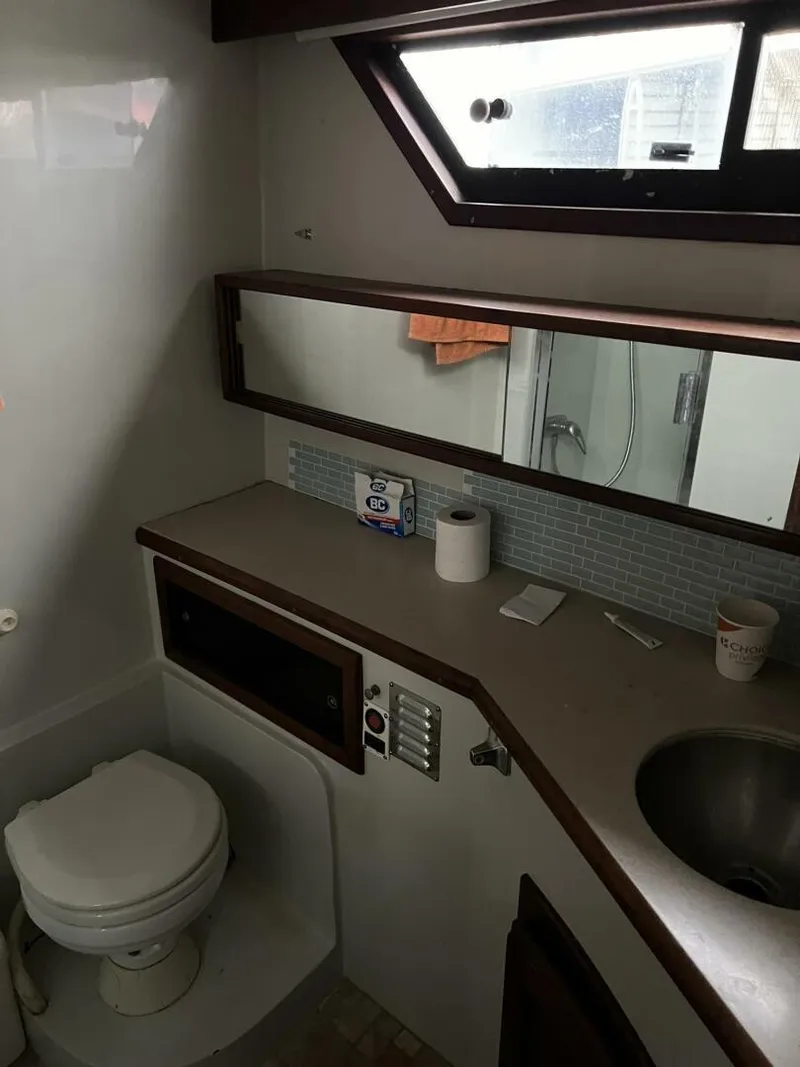 Slide: The Image of Bathroom interior of 1987 Californian 42 Motor Yacht with toilet, sink, and mirror. - 23
