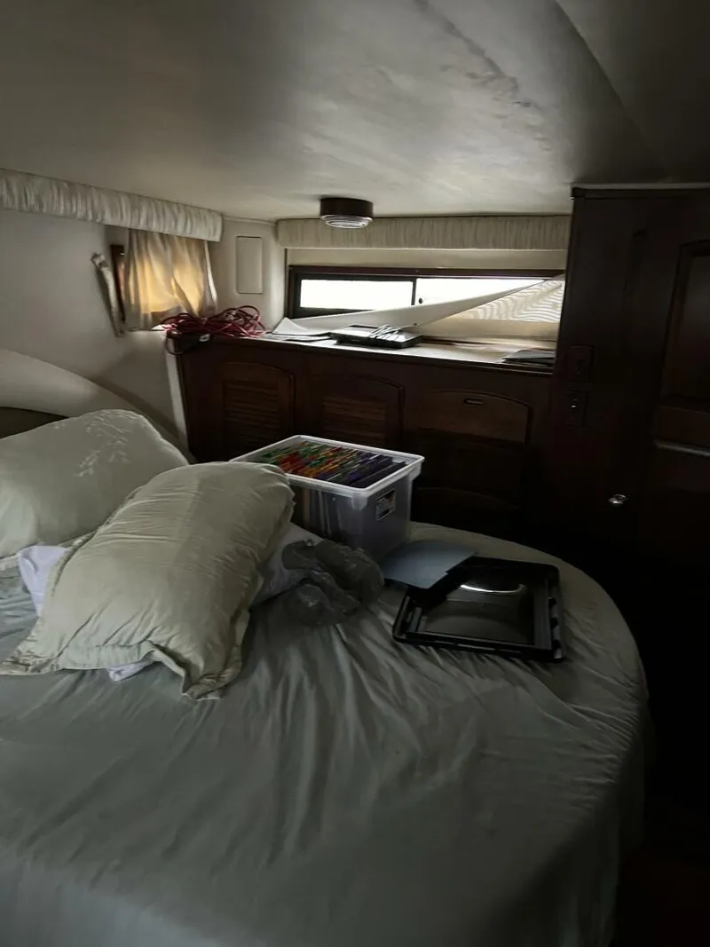 Slide: The Image of Cozy bedroom interior of 1987 Californian 42 Motor Yacht with bed and storage. - 25