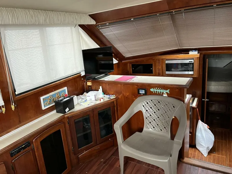 Slide: The Image of Interior of 1987 Californian 42 Motor Yacht with wooden cabinetry and seating. - 6