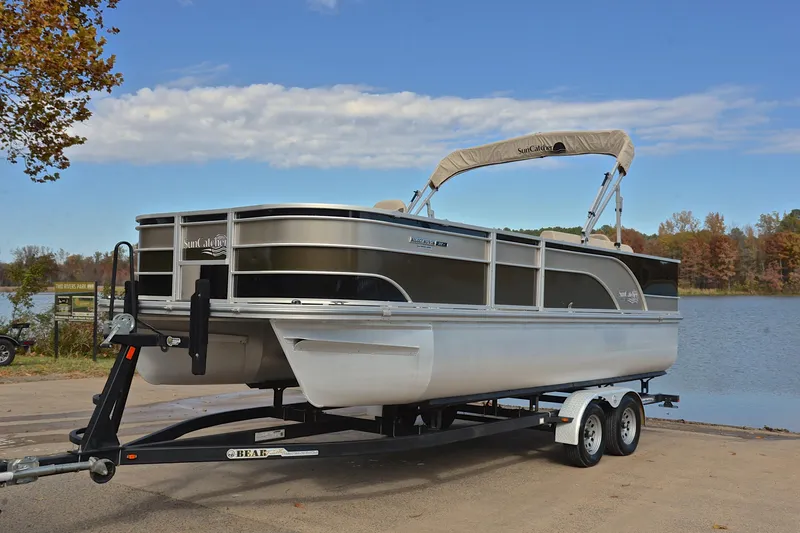 Slide: The Image of 2023 SunCatcher Select 22F pontoon boat on trailer by a scenic lake. - 10